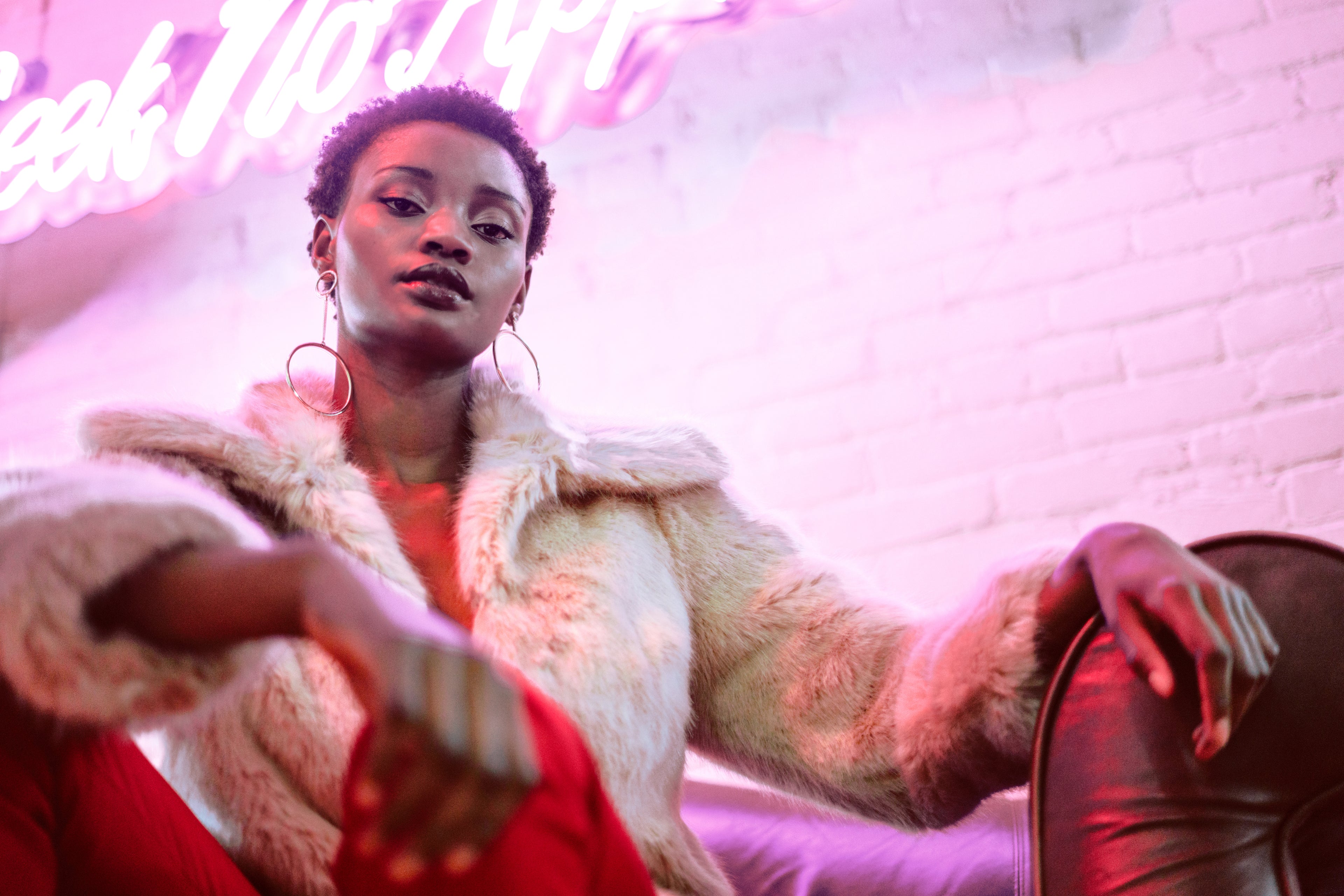 Fashion model with pink neon lighting showcasing Dubai fragrance collection